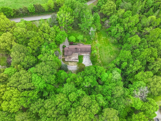 birds eye view of property featuring a view of trees