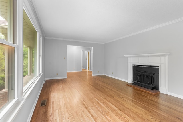 unfurnished living room with a fireplace with raised hearth, light wood-type flooring, and baseboards