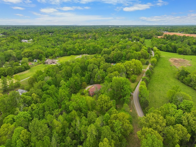 drone / aerial view featuring a wooded view