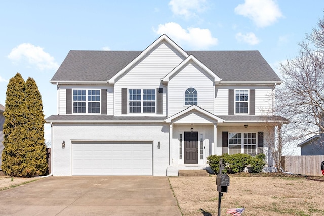 traditional-style house featuring brick siding, fence, concrete driveway, roof with shingles, and an attached garage