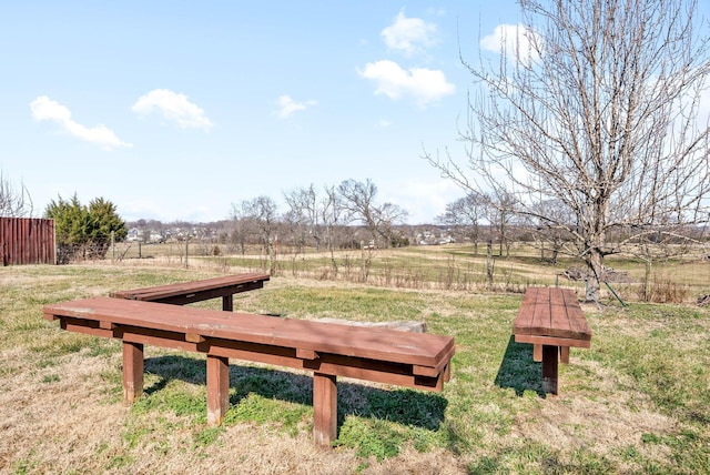 view of yard with a rural view and fence