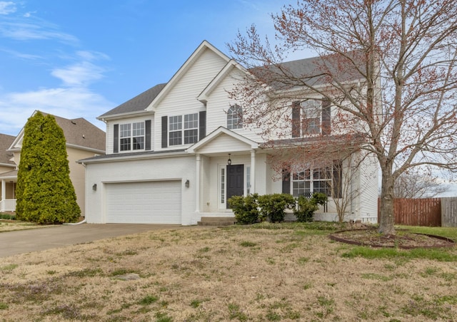 traditional-style house featuring brick siding, a front lawn, fence, concrete driveway, and an attached garage