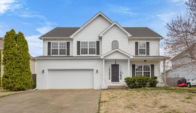 traditional-style house with brick siding, driveway, and a garage