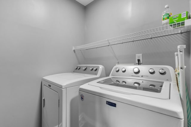 laundry area featuring separate washer and dryer and laundry area