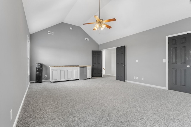 unfurnished bedroom with visible vents, light carpet, and high vaulted ceiling