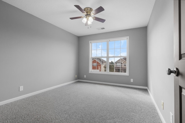 spare room with visible vents, baseboards, carpet, and ceiling fan