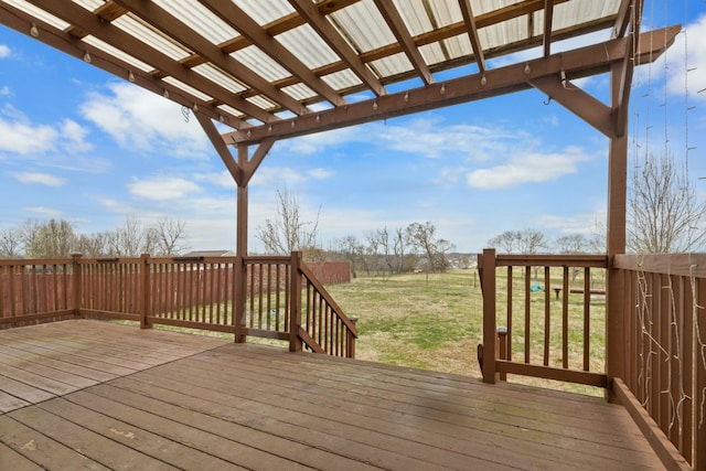 deck with a rural view and a yard