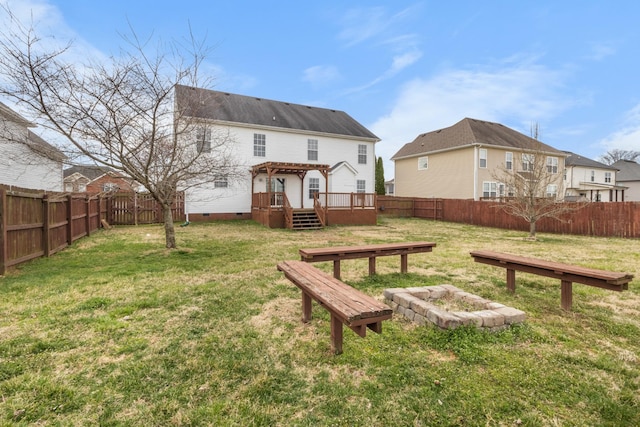 back of house with a fenced backyard, a pergola, a fire pit, crawl space, and a lawn