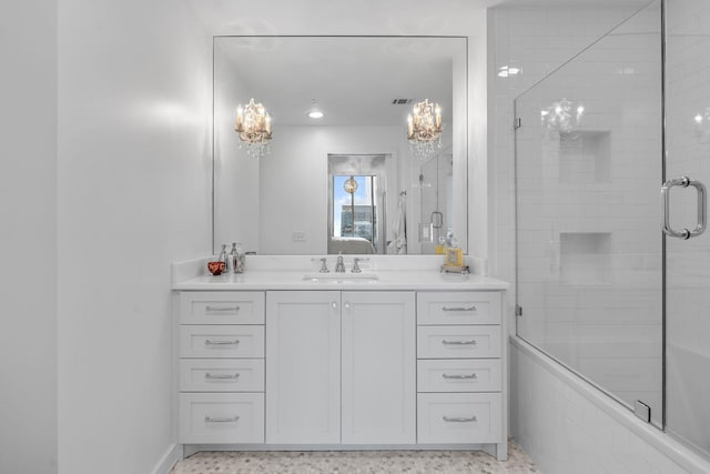 full bathroom with a tile shower, vanity, and baseboards