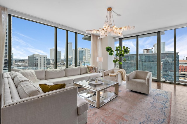 living room with a wealth of natural light, a view of city, hardwood / wood-style floors, and floor to ceiling windows