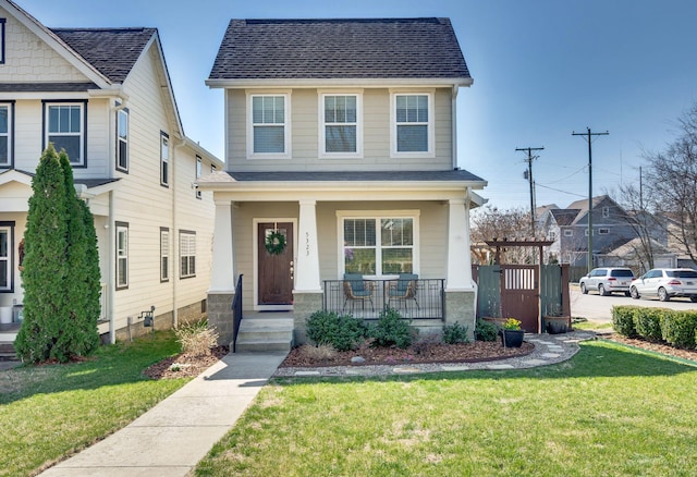 view of front of house with a porch and a front lawn