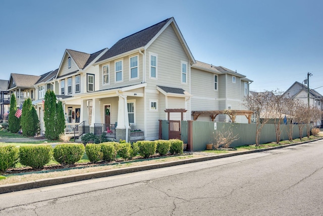 view of front of house featuring fence and a residential view