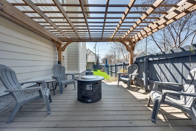 deck with a pergola and a fenced backyard