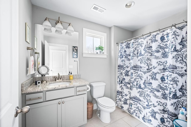 bathroom featuring vanity, a shower with curtain, visible vents, tile patterned flooring, and toilet