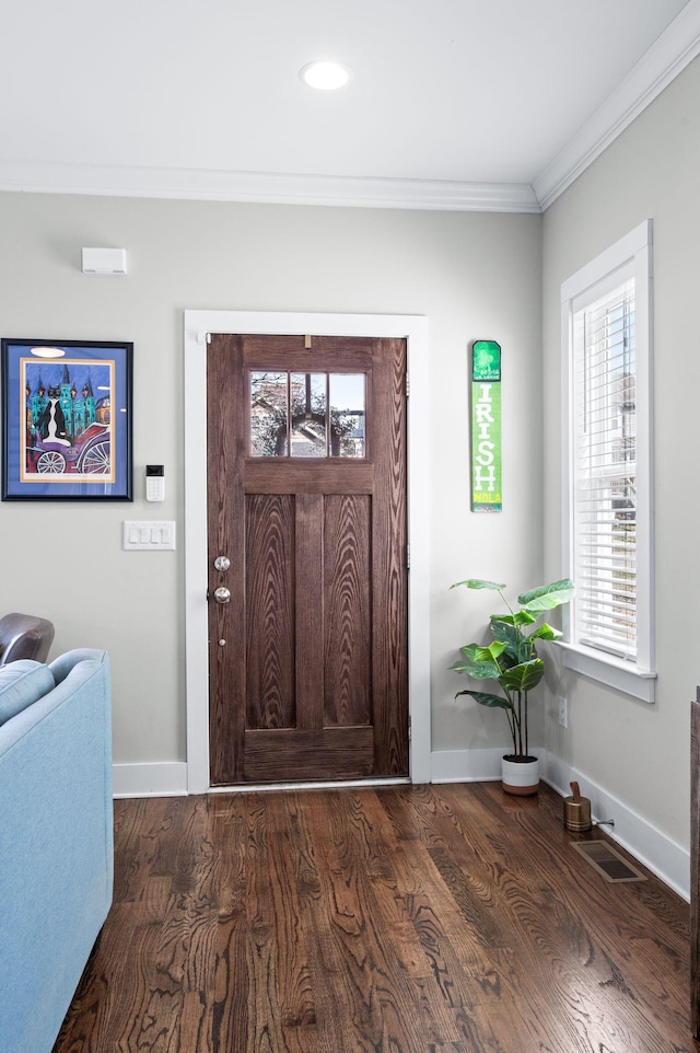 foyer entrance with wood finished floors, visible vents, baseboards, recessed lighting, and ornamental molding