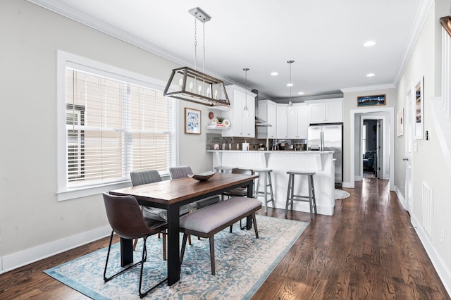 dining room with dark wood finished floors, crown molding, recessed lighting, and baseboards