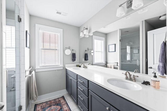 full bathroom featuring a sink, baseboards, double vanity, and a shower stall