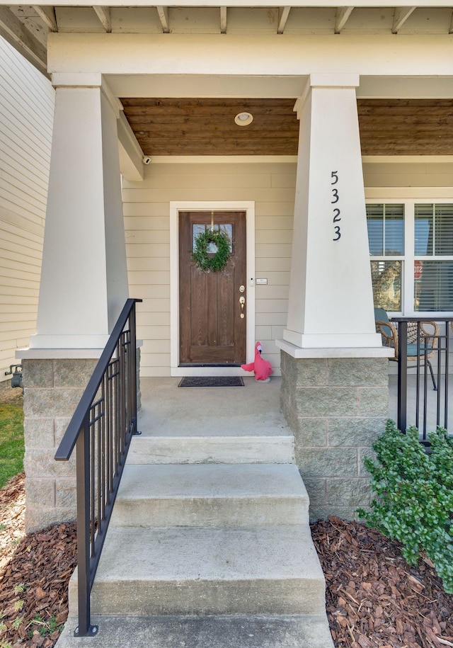 view of exterior entry featuring a porch