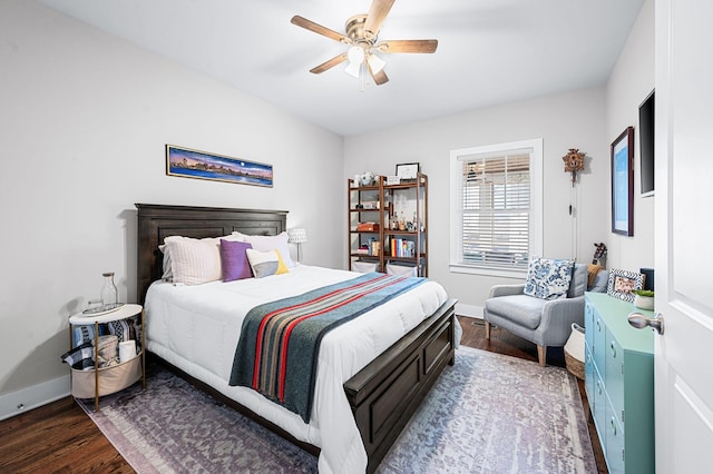 bedroom featuring ceiling fan, baseboards, and wood finished floors