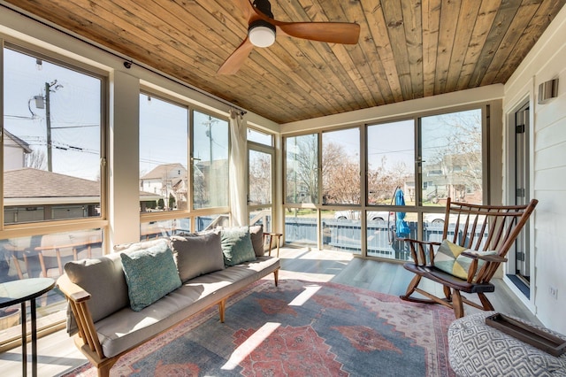 sunroom / solarium featuring wooden ceiling and ceiling fan