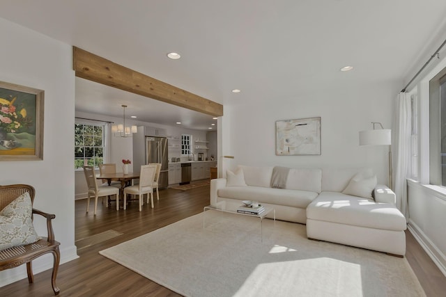 living room featuring baseboards, beamed ceiling, recessed lighting, wood finished floors, and a notable chandelier