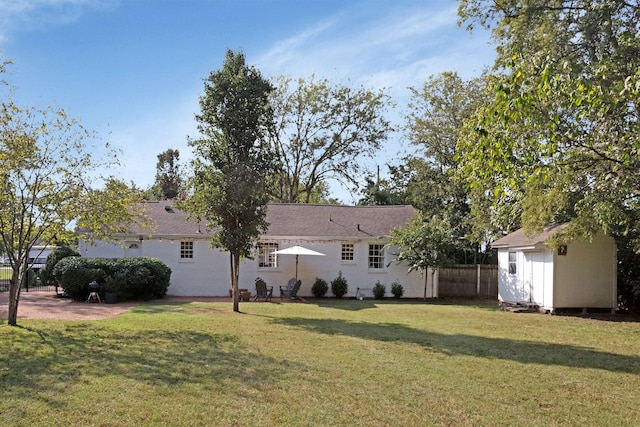 view of yard with an outbuilding, a storage shed, and fence