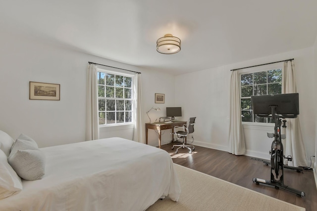 bedroom with wood finished floors and baseboards