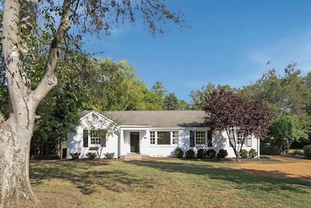 ranch-style home with a front lawn