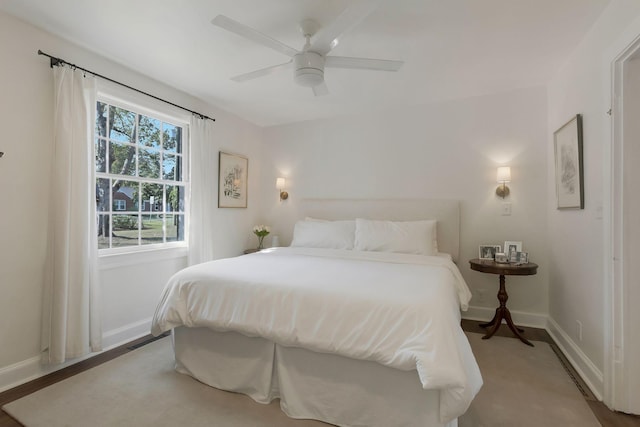 bedroom with ceiling fan and baseboards