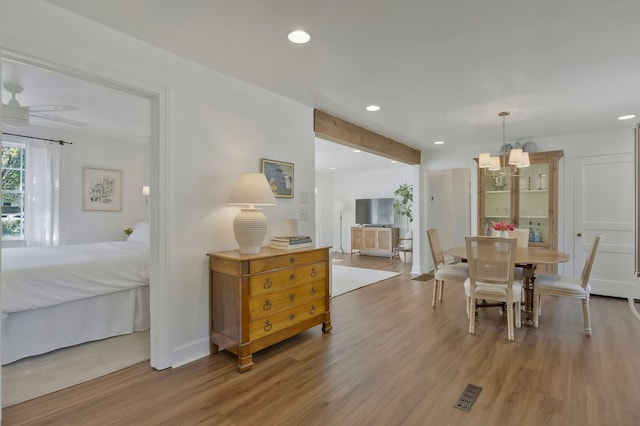 dining room with light wood finished floors, visible vents, baseboards, recessed lighting, and a notable chandelier