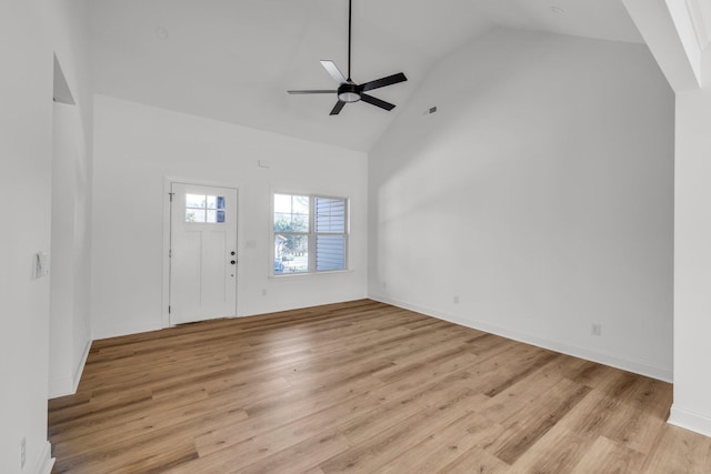 entryway with a ceiling fan, baseboards, light wood-style floors, and high vaulted ceiling