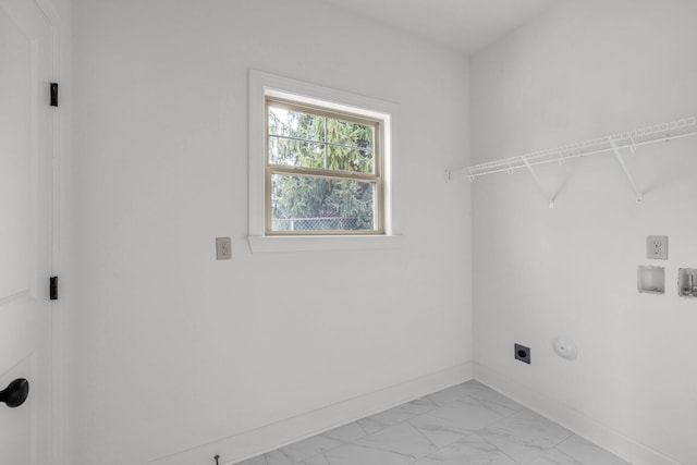 laundry room with electric dryer hookup, baseboards, marble finish floor, and laundry area