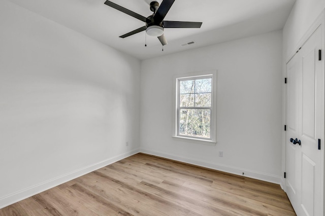 unfurnished bedroom with light wood-style flooring, visible vents, baseboards, and a closet