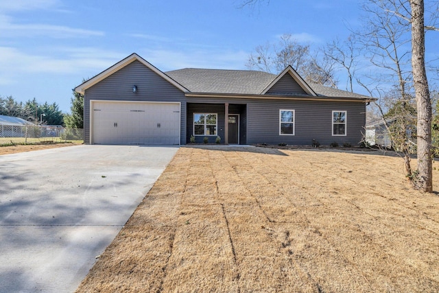 ranch-style home featuring fence, a garage, driveway, and a shingled roof