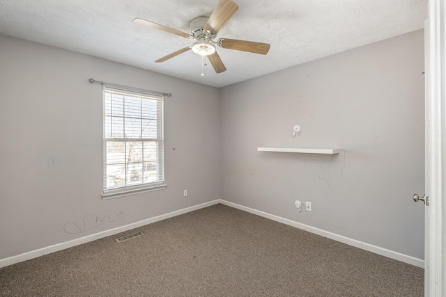 empty room with visible vents, a textured ceiling, baseboards, and carpet floors