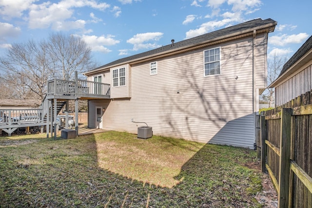 rear view of property featuring stairway, fence, a yard, a deck, and central air condition unit