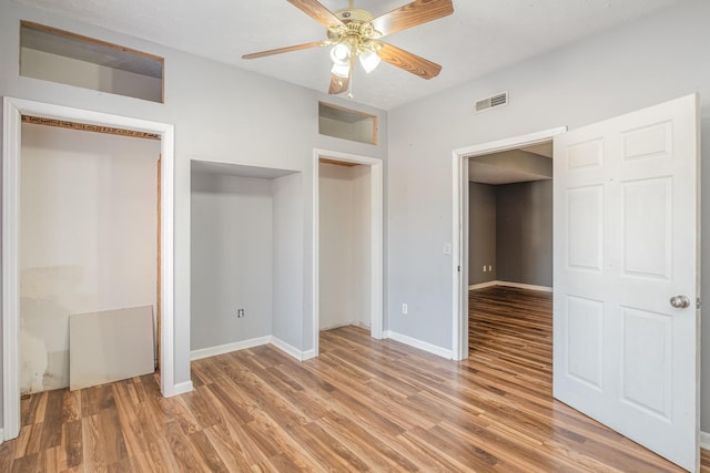 unfurnished bedroom with ceiling fan, light wood-style floors, visible vents, and baseboards