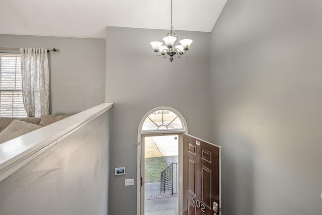 foyer entrance featuring an inviting chandelier