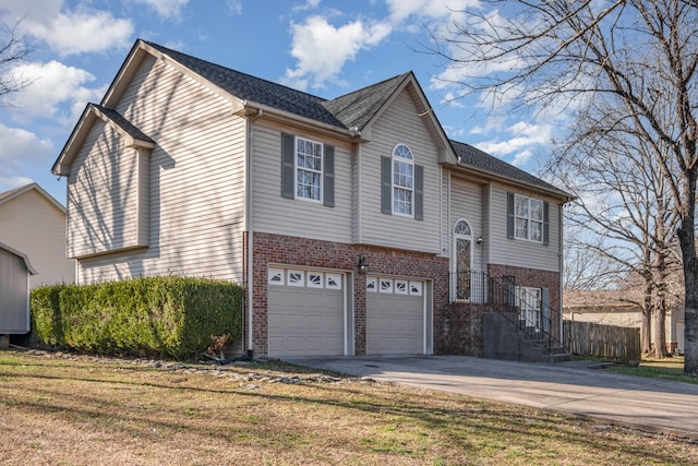 view of front of house featuring concrete driveway, an attached garage, brick siding, and a front yard