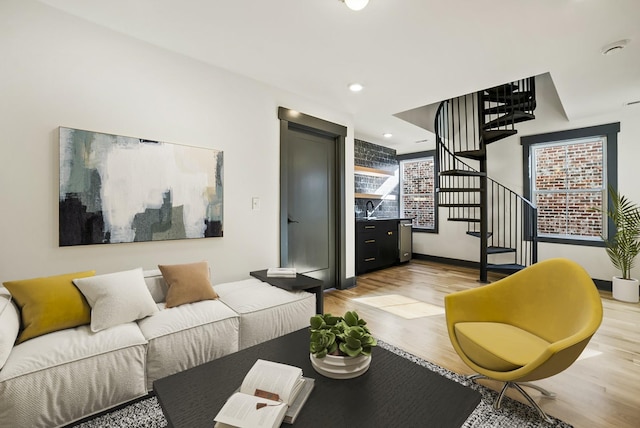 living area featuring recessed lighting, stairway, light wood-style flooring, and baseboards