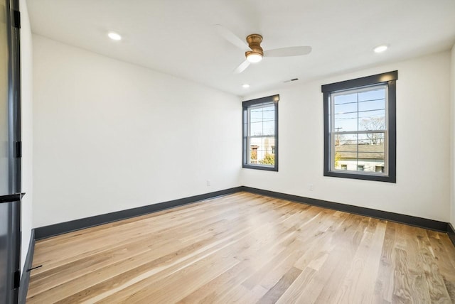 empty room featuring recessed lighting, baseboards, light wood-style floors, and a ceiling fan