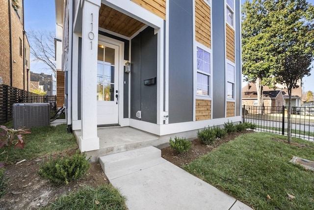 doorway to property with fence and central AC