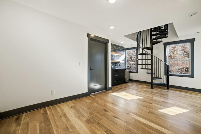 foyer entrance with recessed lighting, light wood-type flooring, baseboards, and stairway