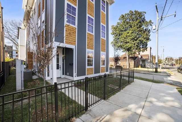 view of building exterior featuring a fenced front yard