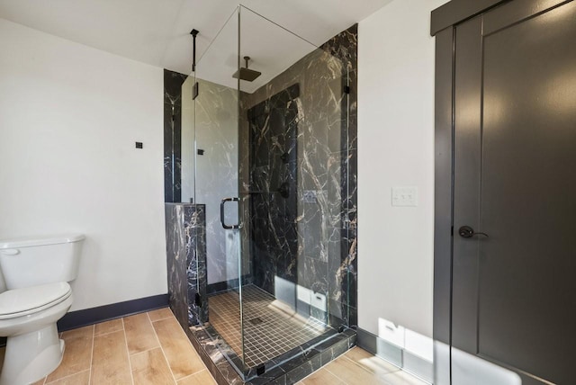 bathroom featuring a marble finish shower, wood finish floors, toilet, and baseboards