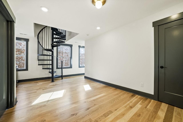 interior space with recessed lighting, baseboards, stairs, and light wood-style floors