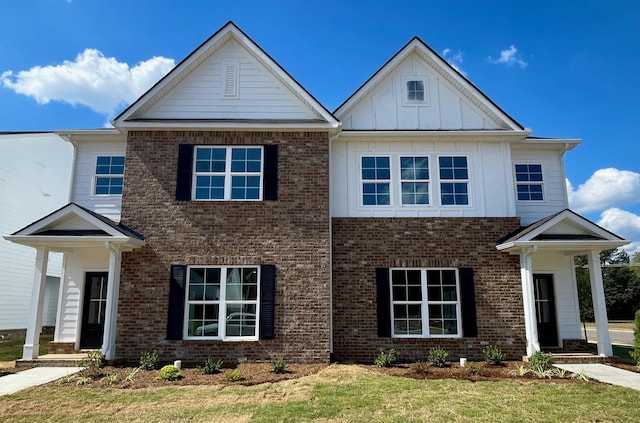 view of front of home with brick siding and board and batten siding