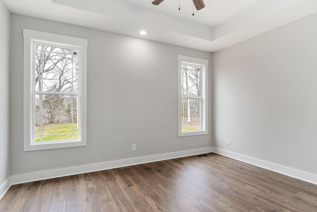 spare room featuring recessed lighting, ceiling fan, baseboards, and dark wood-style flooring