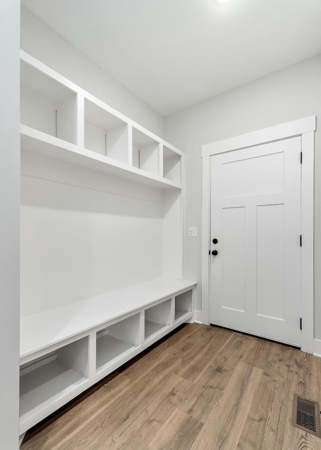 mudroom featuring visible vents and wood finished floors