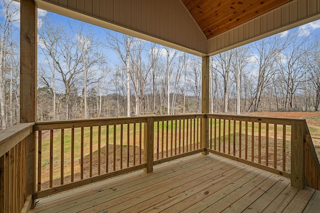 wooden deck with a wooded view